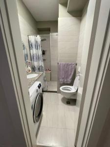 a small bathroom with a toilet and a sink at Garden Building Luxury Apartment in Tirana