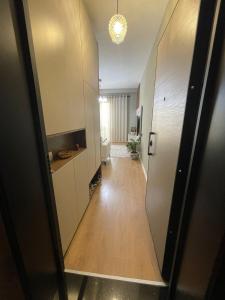a hallway leading to a room with a hallway at Garden Building Luxury Apartment in Tirana