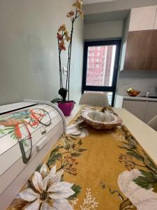 a room with a bed with a table with a rug at Garden Building Luxury Apartment in Tirana