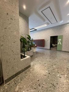 an empty room with a plant in a building at Garden Building Luxury Apartment in Tirana