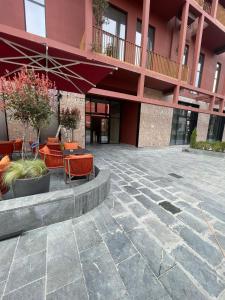 a courtyard with chairs and tables in front of a building at Garden Building Luxury Apartment in Tirana