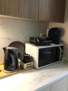 a microwave sitting on top of a kitchen counter at Garden Building Luxury Apartment in Tirana