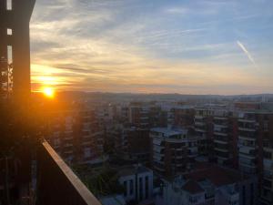 a sunset over a city with tall buildings at Garden Building Luxury Apartment in Tirana