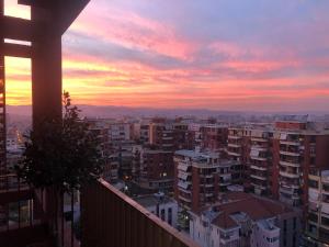 a view of a city at sunset at Garden Building Luxury Apartment in Tirana
