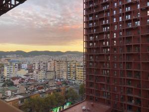 a view of a city with a tall building at Garden Building Luxury Apartment in Tirana
