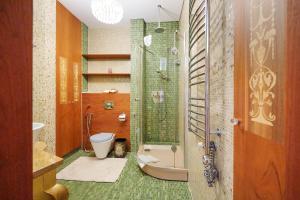 a bathroom with a shower and a toilet and a sink at Helios Extra Apartment in Vilnius skyscraper 20 floor in Vilnius +51 photos