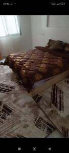 a bed is covered in a plastic sheet at Appartement meublé in Meknès