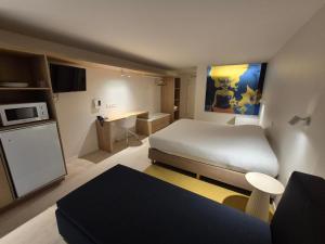 Voodi või voodid majutusasutuse Hotel Corbie Geel toas +30 fotot
