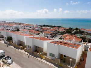 a view of a city with white buildings and the ocean at Ericeira Panoramic Sea View Apartments in Ericeira