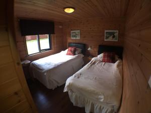 Postel nebo postele na pokoji v ubytování Lochlomondlodge22
