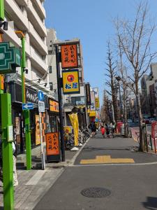 a street with signs on the side of the road at Colin Home Intimo Amigo in Tokyo