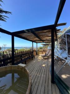 a wooden deck with a hot tub and a wooden table at Domos de Matanzas in Matanzas +84 photos