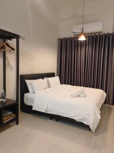 a bedroom with a bed with white sheets and a window at KLIA AIRPORT HOMESTAY in Sepang +16 photos