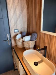 a bathroom with baskets on a counter next to a sink at Domos de Matanzas in Matanzas