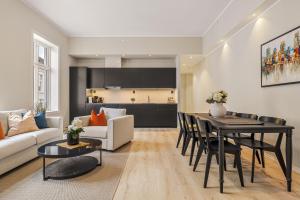 a living room with a table and a kitchen at Rosenberg Apartments in Bergen