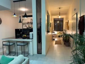 a kitchen and living room with a table and chairs at Aksil Jaam in Dakar