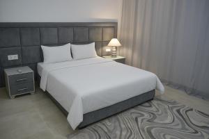 a large white bed in a hotel room at Atlas Royale Marrakech in Marrakesh +32 photos