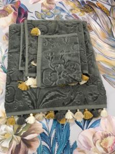 a blanket on a bed with flowers on it at Luxury Apartment Treviso and Venice in Treviso