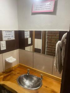 a bathroom with a sink and a mirror at Monoambientes CDM in Capilla del Monte