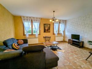 a living room with a couch and a table at Maison familiale charme à Wavrille, proche Verdun - FR-1-585-169 in Wavrille