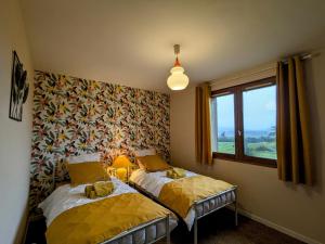 a bedroom with two beds and a window at Maison familiale charme à Wavrille, proche Verdun - FR-1-585-169 in Wavrille