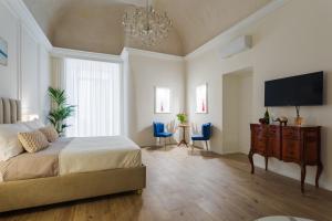a bedroom with a bed and a flat screen tv at Angiolina Suite in Naples