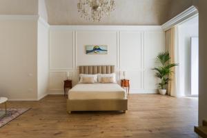 a bedroom with a bed and a chandelier at Angiolina Suite in Naples