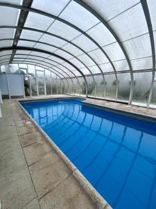 a large swimming pool with a domed ceiling at Cabañas Buena Vista in Sierra de la Ventana