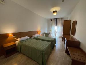 Postel nebo postele na pokoji v ubytování Hotel Clementi