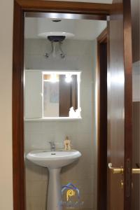 a bathroom with a sink and a mirror at Blu Celeste - by AP Apartment in Baia Verde +16 photos