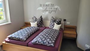 a bedroom with two beds and a sign on the wall at Schmallenberger Auszeit in Schmallenberg