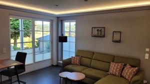 a living room with a couch and a table at Schmallenberger Auszeit in Schmallenberg
