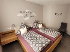 a bedroom with two beds and a desk and a chair at Schmallenberger Auszeit in Schmallenberg +17 photos