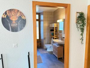 a bathroom with a toilet and a sink at Votre oasis au cœur de Lausanne in Lausanne