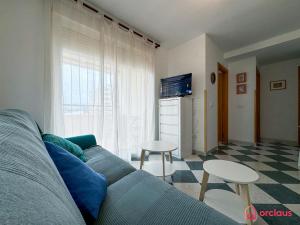 a living room with a couch and a table at La Marina in Oropesa del Mar