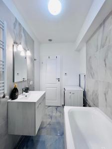 a white bathroom with a tub and a sink at Escape Retreat I 3 BR house near Buftea in Săbăreni +33 photos