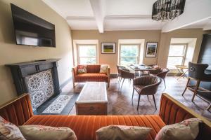 een woonkamer met open haard en een eetkamer bij The Richmond Suite in Marske