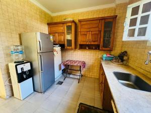 a kitchen with a refrigerator and a sink at Marseilia beach2 in Al Ḩammām
