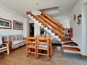 a staircase in a living room with a table and chairs at Casa Giuseppina in Temù