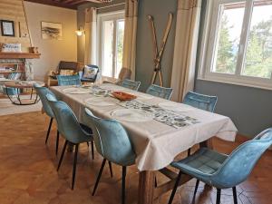 a dining room with a table and chairs at Le Temps des Cerises in Saint-Georges-en-Couzan +52 photos