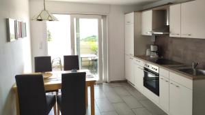 a kitchen with a table and a dining room at Appartement In Medenscheid Mit Garten Und Terrasse in Bacharach