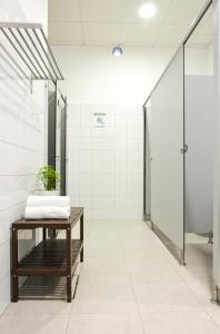 a bathroom with a table with a plant on it at Albergue Melide in Melide +35 photos
