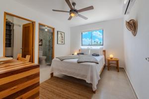 a bedroom with a bed and a ceiling fan at la maguana - cozy and beautiful 3BR home with pool in Santiago de los Caballeros
