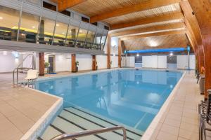 a large swimming pool in a building at Woodford Bridge Country Club in Milton Damerel