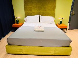 Giường trong phòng chung tại Hotel Vitruvio