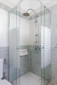 a shower with a glass door in a bathroom at Villa Anthemoessa - Endless Seaview in Pythagoreio