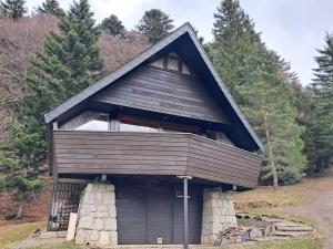 a small house with a gambrel roof on a hill at Mont-Dore : Chalet agréable avec WIFI pour 9 personnes - FR-1-608-88 in Le Mont-Dore +9 photos