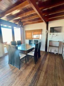 a dining room with a table and chairs at Casa de playa en Wakama in San Vicente de Cañete +2 photos