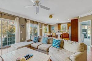 a living room with a couch and a table at Loggerhead - Leatherback #903 in Bethany Beach