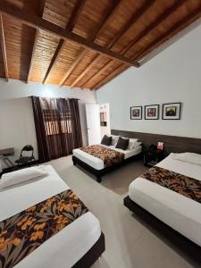 Postel nebo postele na pokoji v ubytování Hotel Quinta Avenida